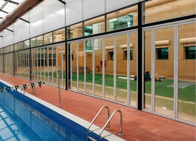 Sliding folding glass partition system for modern office interiors
